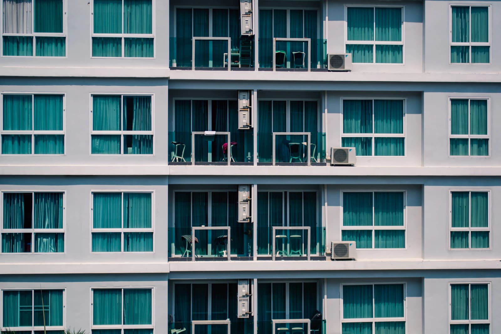 Apartment balconies and windows across a residential building